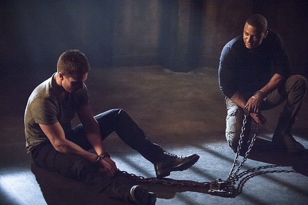 Oliver Queen and John Diggle in chains